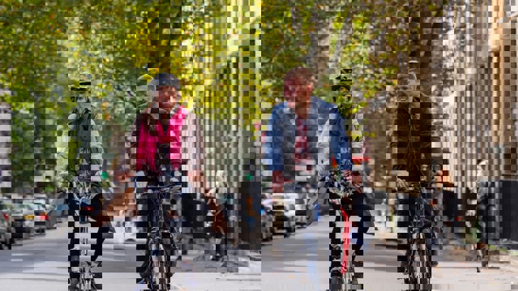 A man And A Woman Cycle On A London Road 