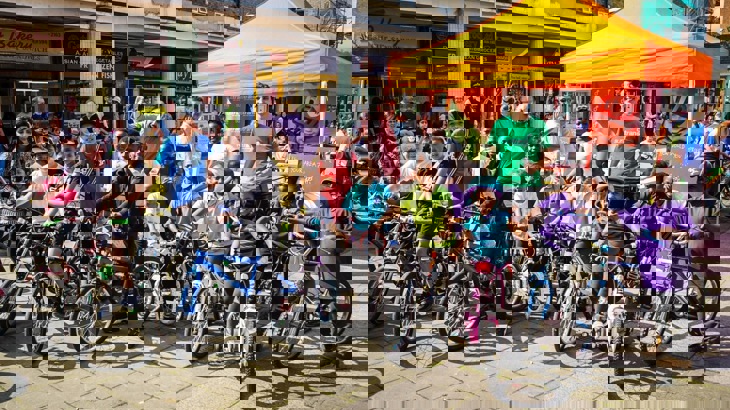 Children on bikes outside of a Walk Wheel Cycle Trust stand in London 