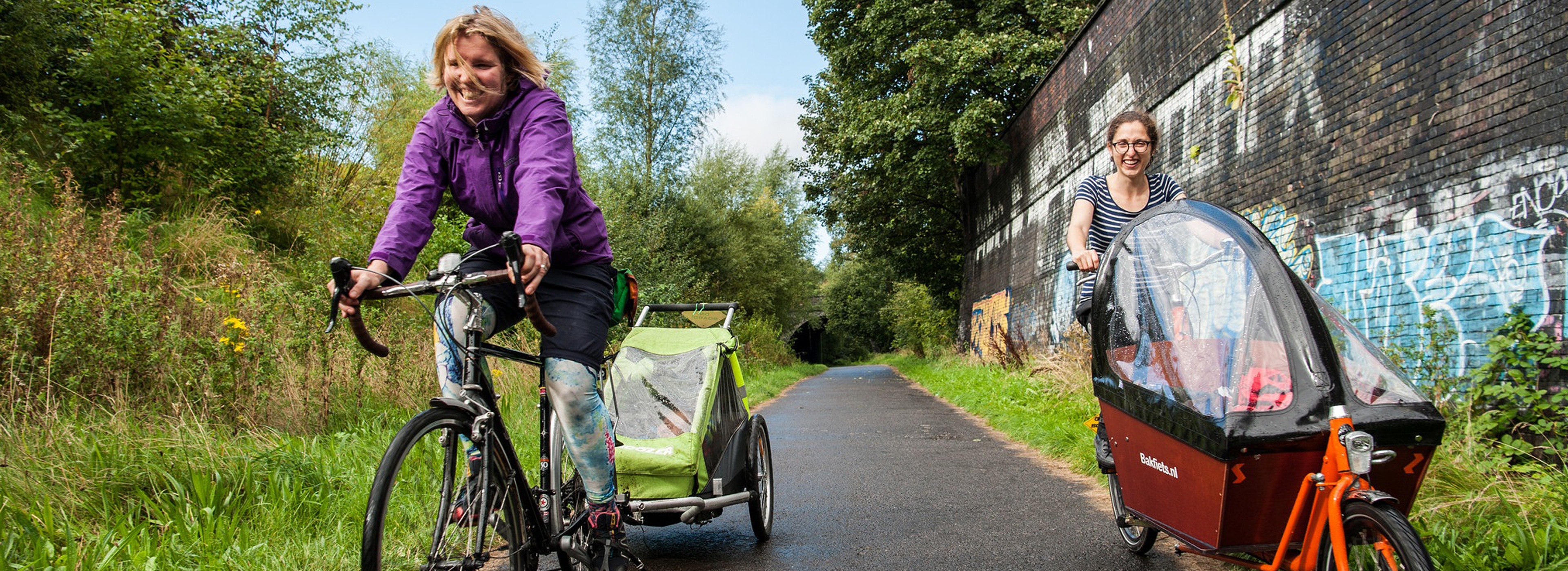 Two women using trailer and cargo bikes