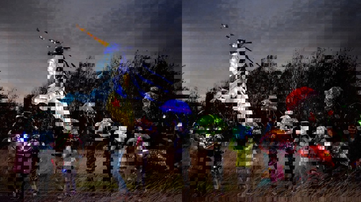 Children holding lit up umbrellas at The Circus of Light