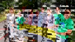 Walk Wheel Cycle Trust staff pose with local residents by the side of the Bristol and Bath Railway Path, holding a public consultation banner.