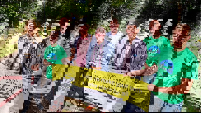 Walk Wheel Cycle Trust staff pose with local residents by the side of the Bristol and Bath Railway Path, holding a public consultation banner.