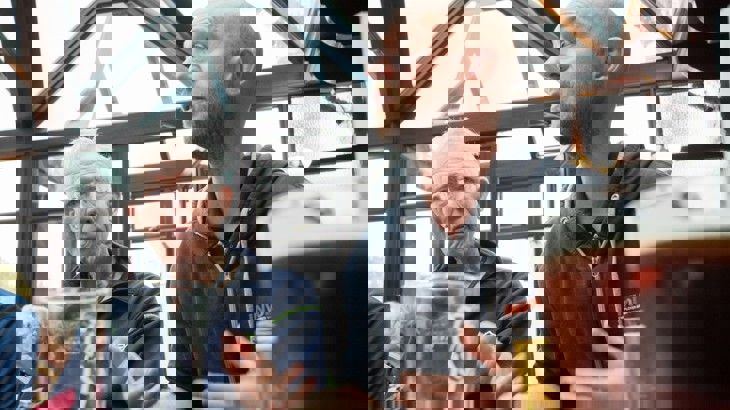 Two men sat in pub with pint glasses and beer 