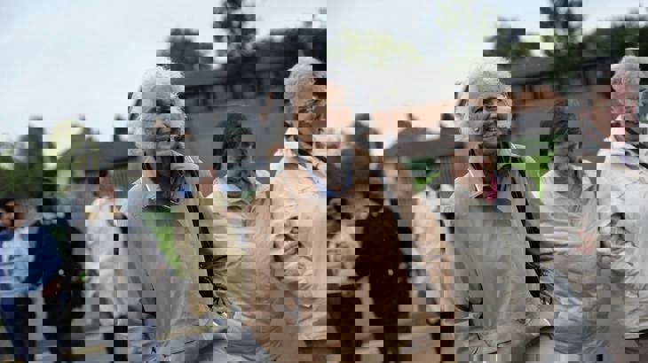 A group of older people walking and smiling together