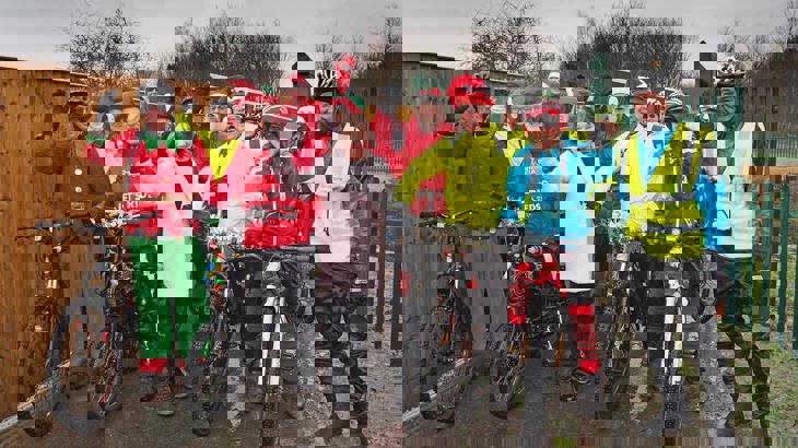 A group of people dressed as Santa and elves pose for a photo on the Castleford Greenway