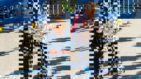 Two children playing outside on their scooters during a School Streets closure in Southampton