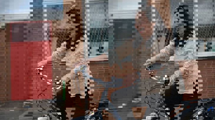 Lady riding a bike and laughing 