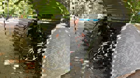 Lady putting her bike into a cycle hangar