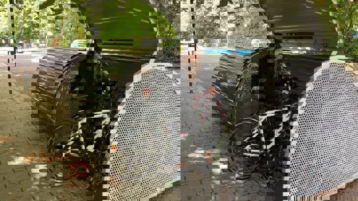 Lady putting her bike into a cycle hangar