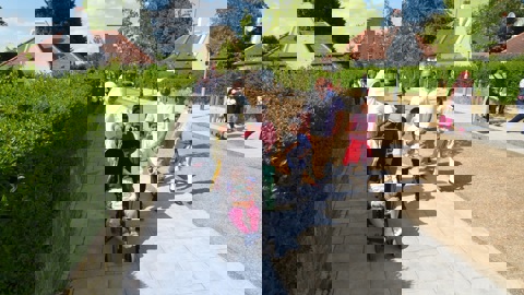 A family walk happily through a traffic free street