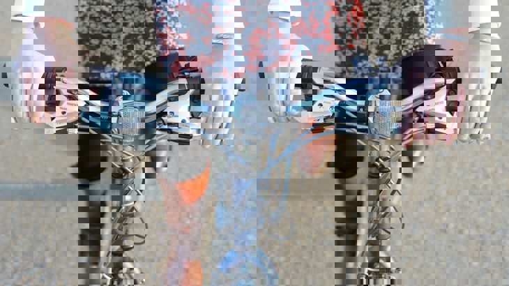 cyclist pushes on the pedals to gain speed