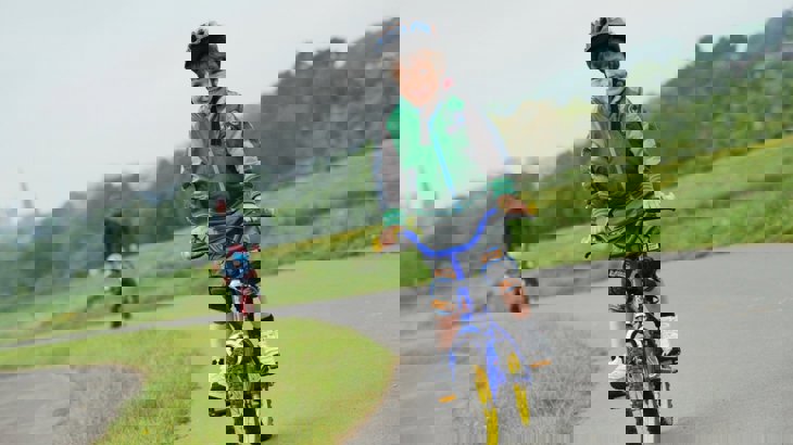 Child cycling alongside river Exe in Exeter