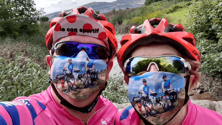 Colin and Diane take a selfie wearing helmets, sunglasses and masks which say "always better when we tandem together"