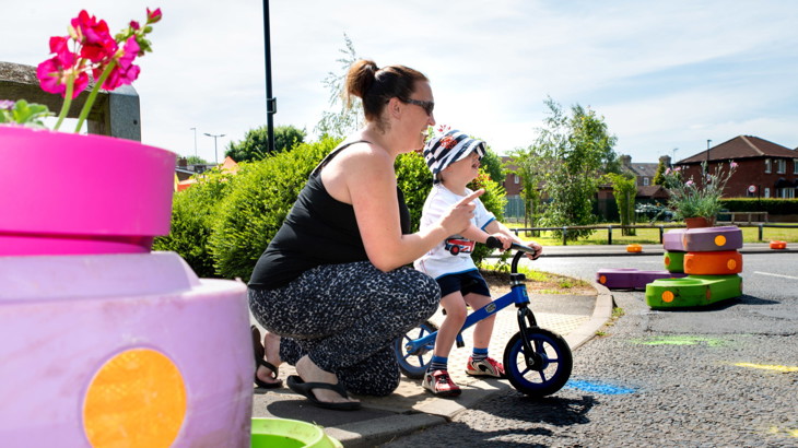 woman and child on bike in school streets