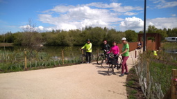 Forth Meadow Community greenway volunteers at National Standard Level 1 cycle training, standing with their bikes on the bridge at Springfield Dam in May 2021