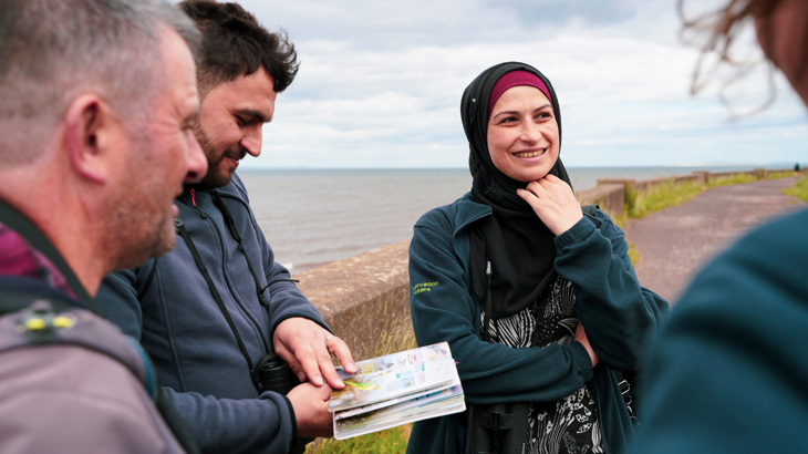 A group of birdwatchers gather on the National Cycle Network route 76