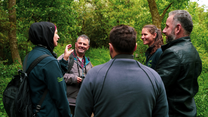 A group of birdwatchers laugh together on the National Cycle Network