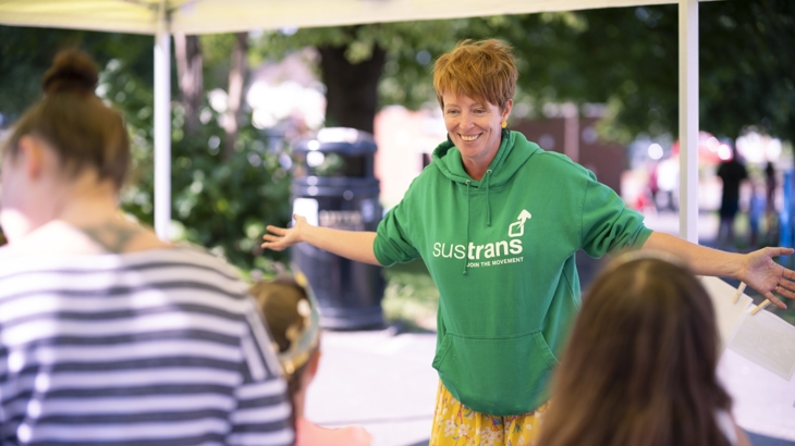 Walk Wheel Cycle Trust event stall, female happily talks to people