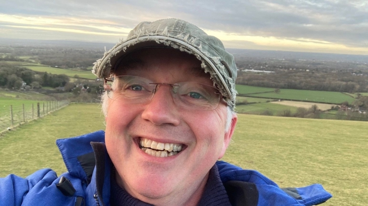 A selfie of Active Travel Officer with natural landscape behind