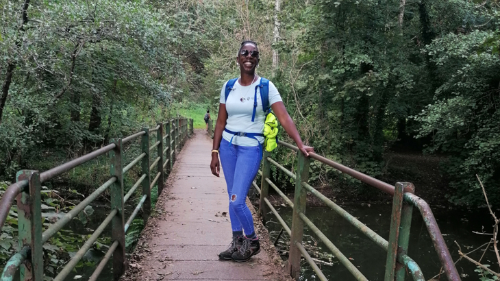 Sophie Brown of Steppin Sistas on a wooden bridge in a woodland.