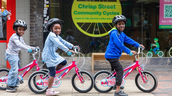 Three children cycling from Chrisp Street Community Cycles hub