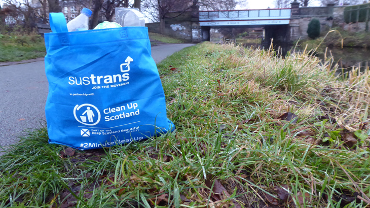 A reusable 2 Minute Clean Up bag, filled with litter, is pictured on the towpath alongside the Union Canal in Edinburgh.