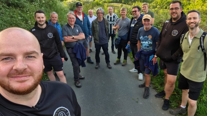 Selfie of Shaun Cook and the Men.Talk.Walk men's mental health walking group on a green country path in Abertridwr, Caerphilly.