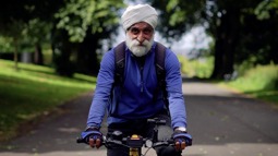 Satwant Singh cycling down a traffic free path on the National Cycle Network in Bradford
