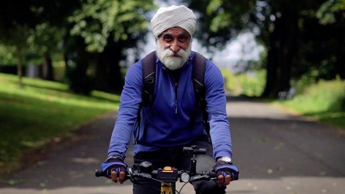 Satwant Singh cycling down a traffic free path on the National Cycle Network in Bradford