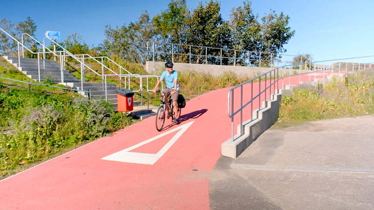 Man on bike using newly installed, fully accessible ramp onto the Cullen to Portknockie path.